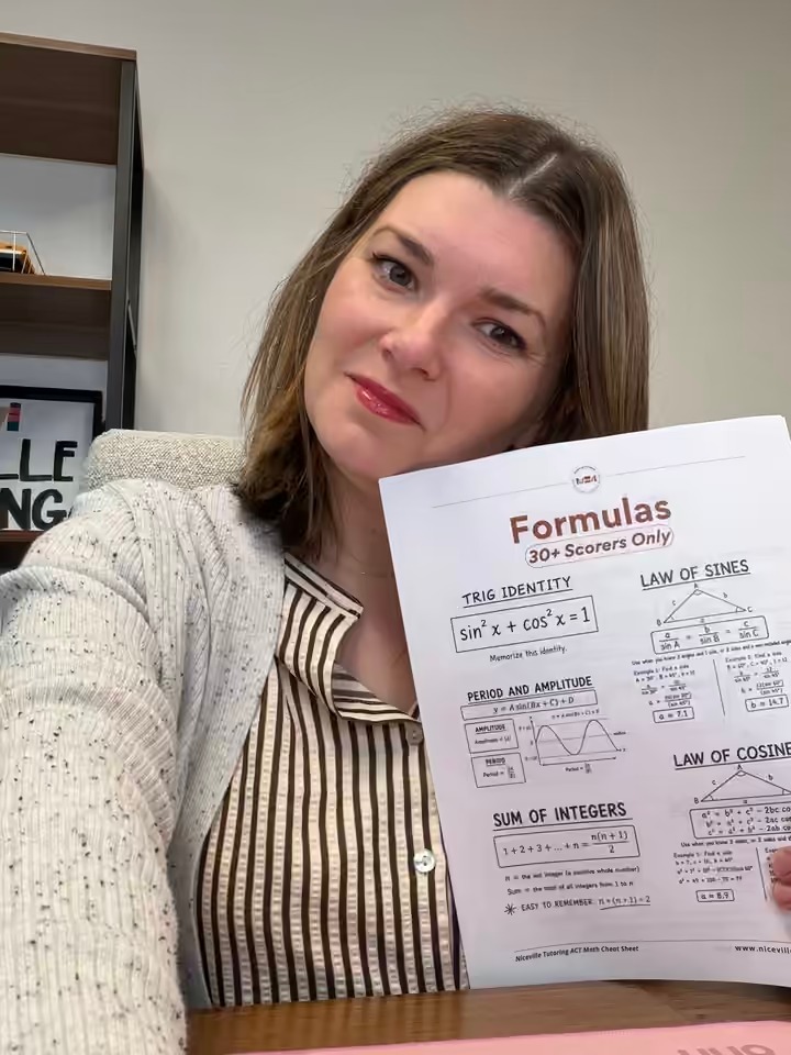 Rebecca Beard holding a printed page of the ACT Math Cheat Sheet