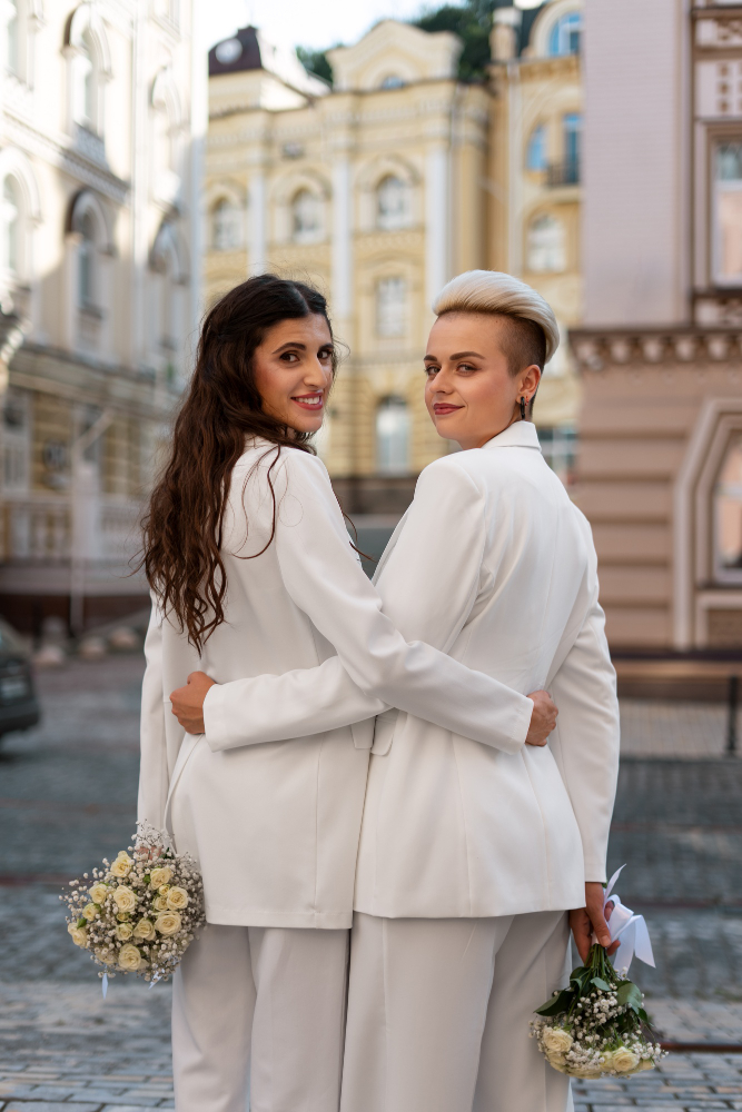 Two brides holding bouquets