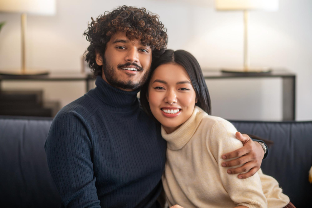 Engaged couple embracing on a couch