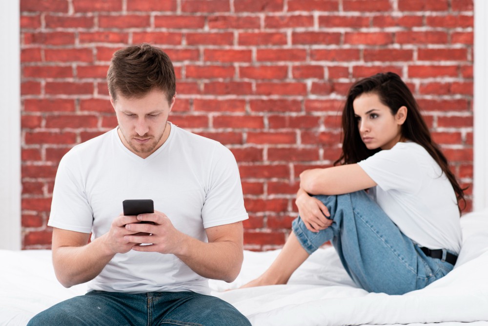 Couple sitting apart, disconnected