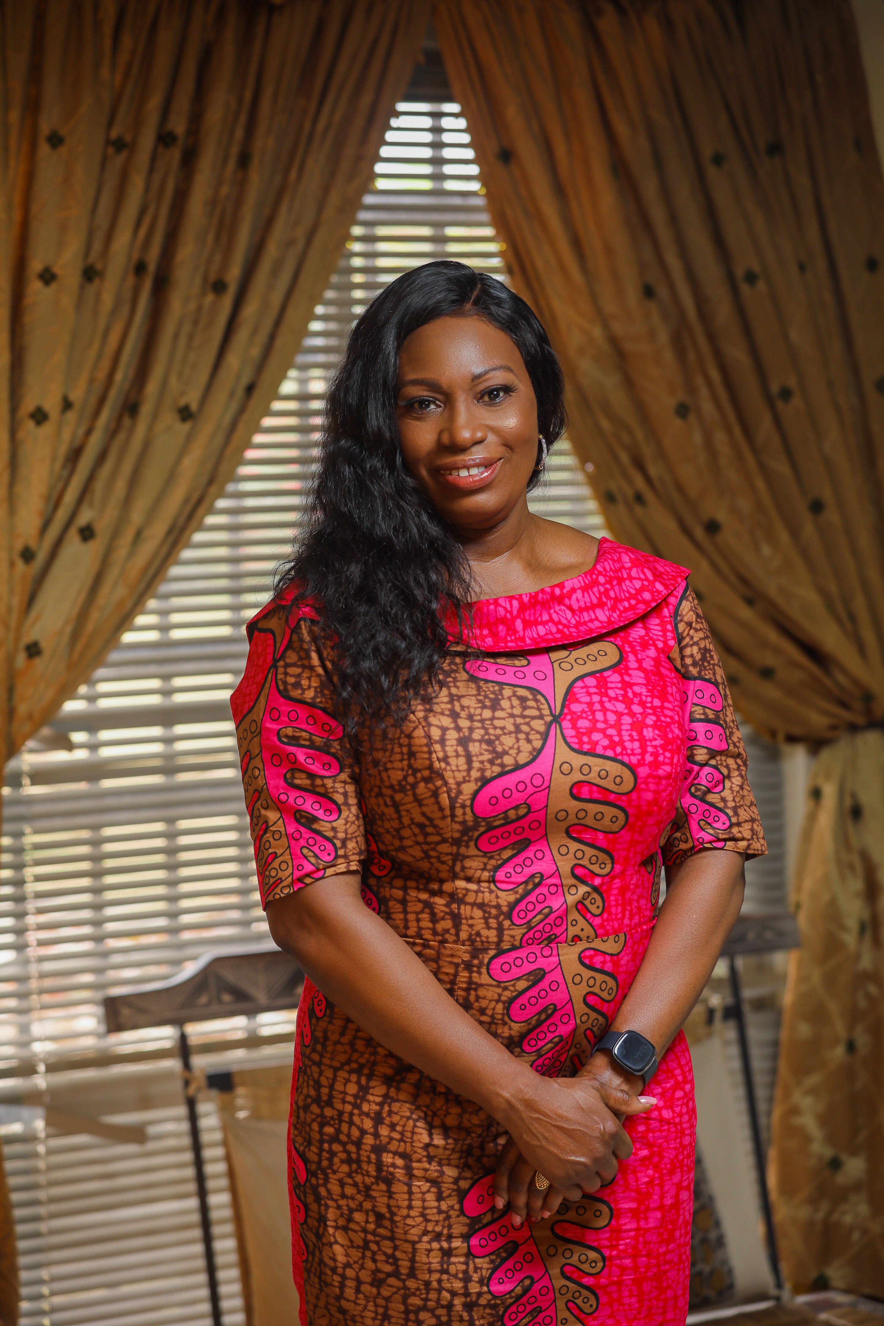Maureen Chiana smiling in a colourful patterned dress