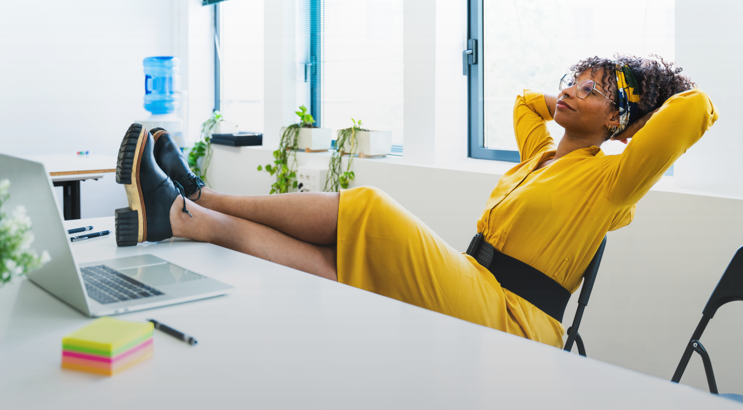 Confident professional woman relaxing at her desk