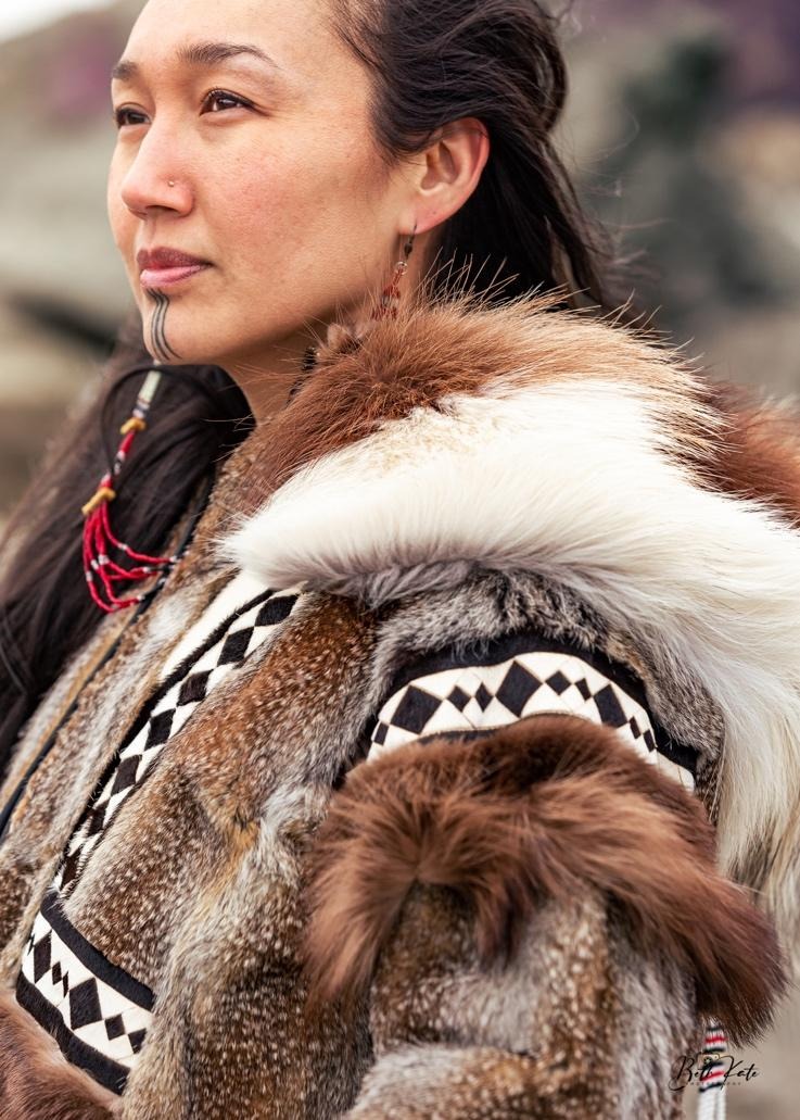 A person wearing a fur coat Description automatically generated with medium confidence