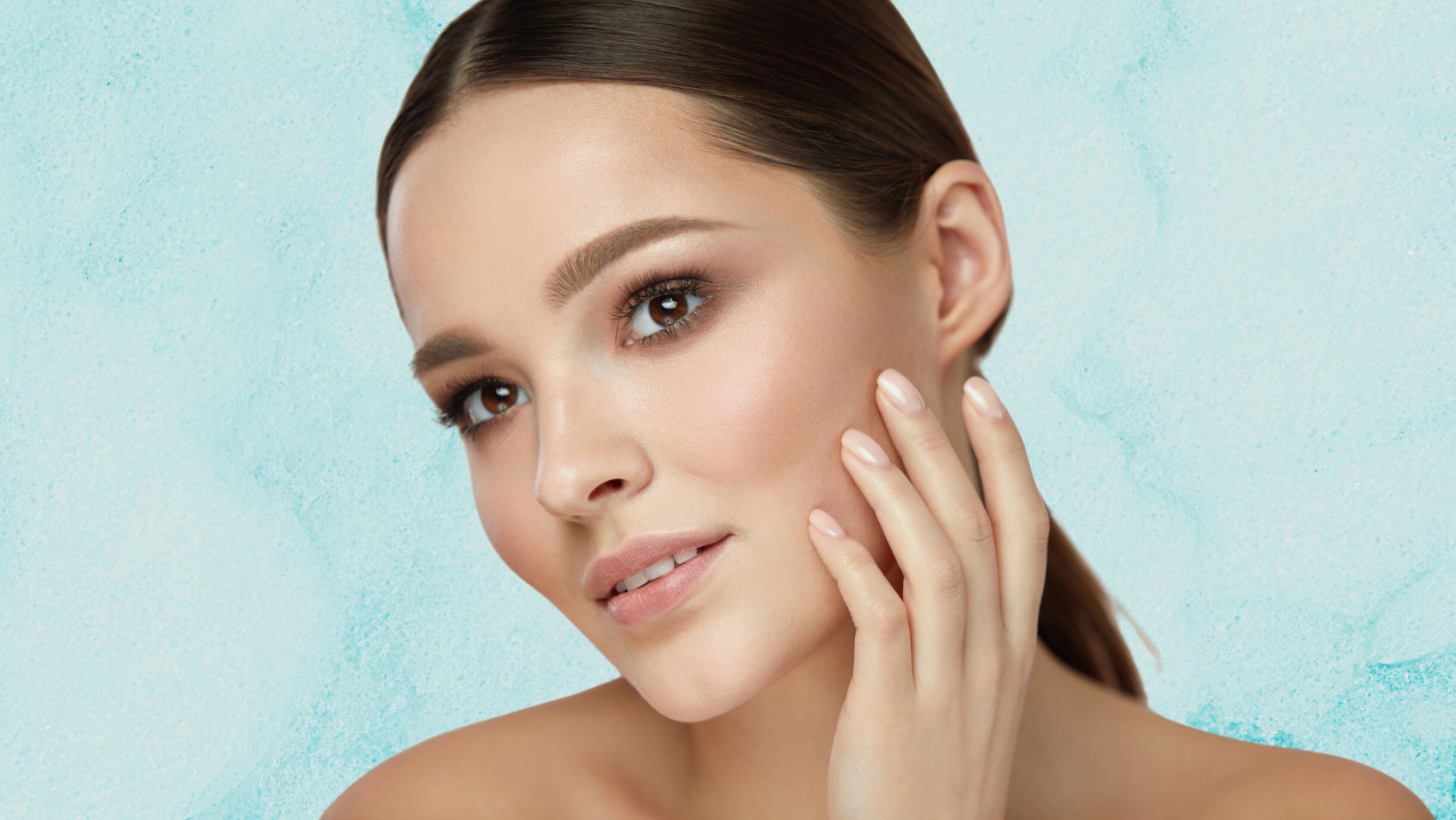 Image of lady on a turquoise background. The woman strokes her own cheek | Acupoint Self-Massage | Do-In | Non-Surgical FaceLift | Kerry Loeb
