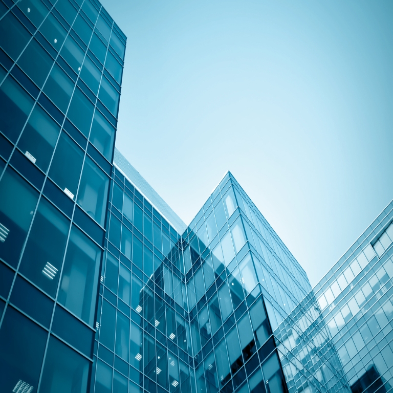 view to steel blue background of glass high rise building