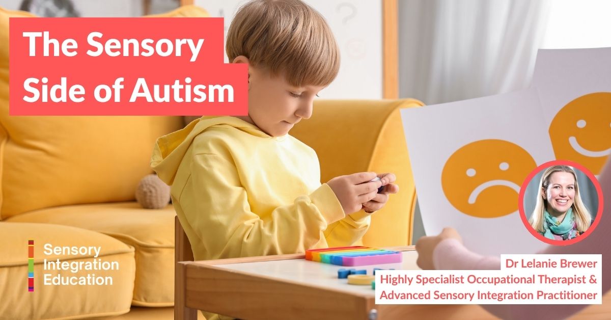 A woman wearing headphones is seated at a desk. She makes notes on a form whilst watching a laptop.