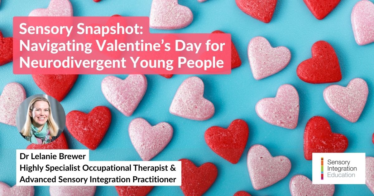 A woman wearing headphones is seated at a desk. She makes notes on a form whilst watching a laptop.