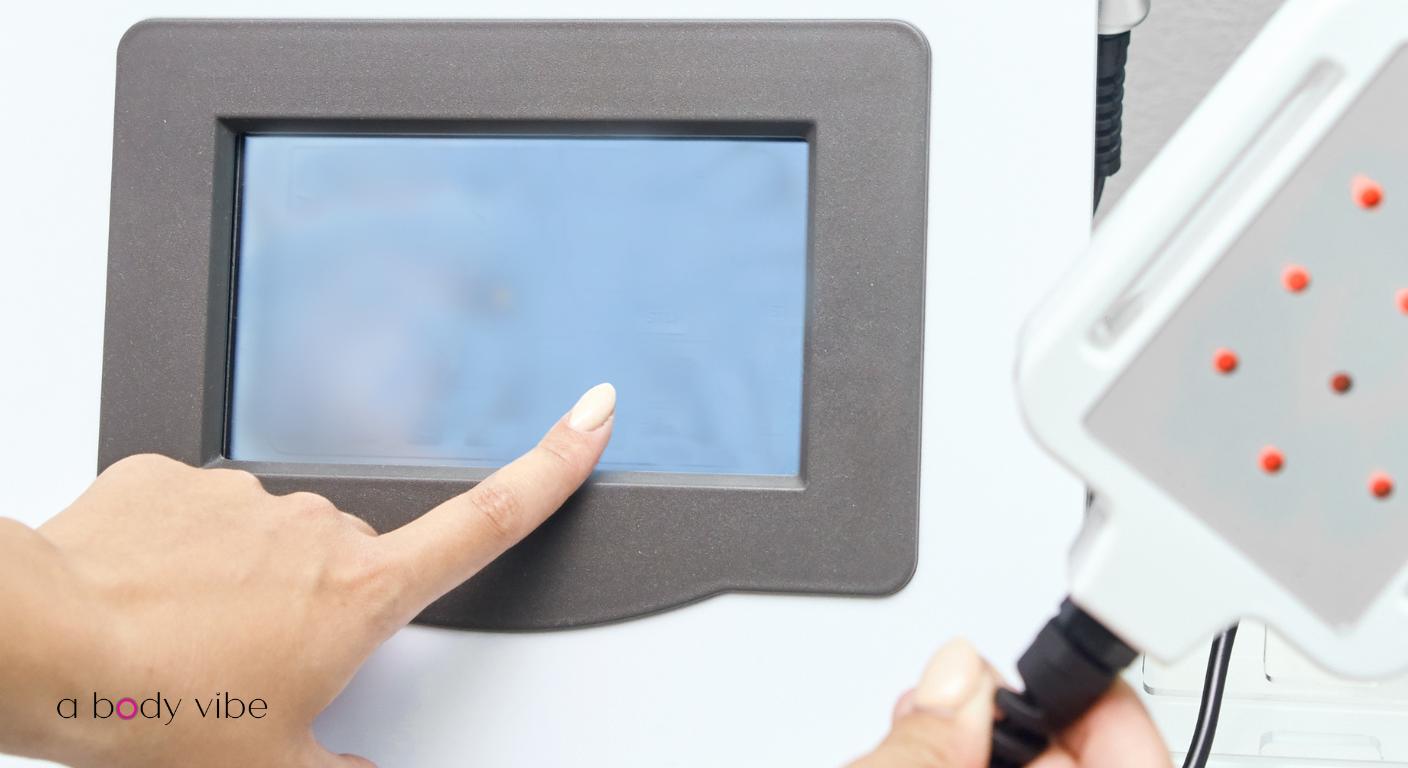 Professional ultrasonic cavitation machine screen showing adjustable frequency and intensity settings for body sculpting