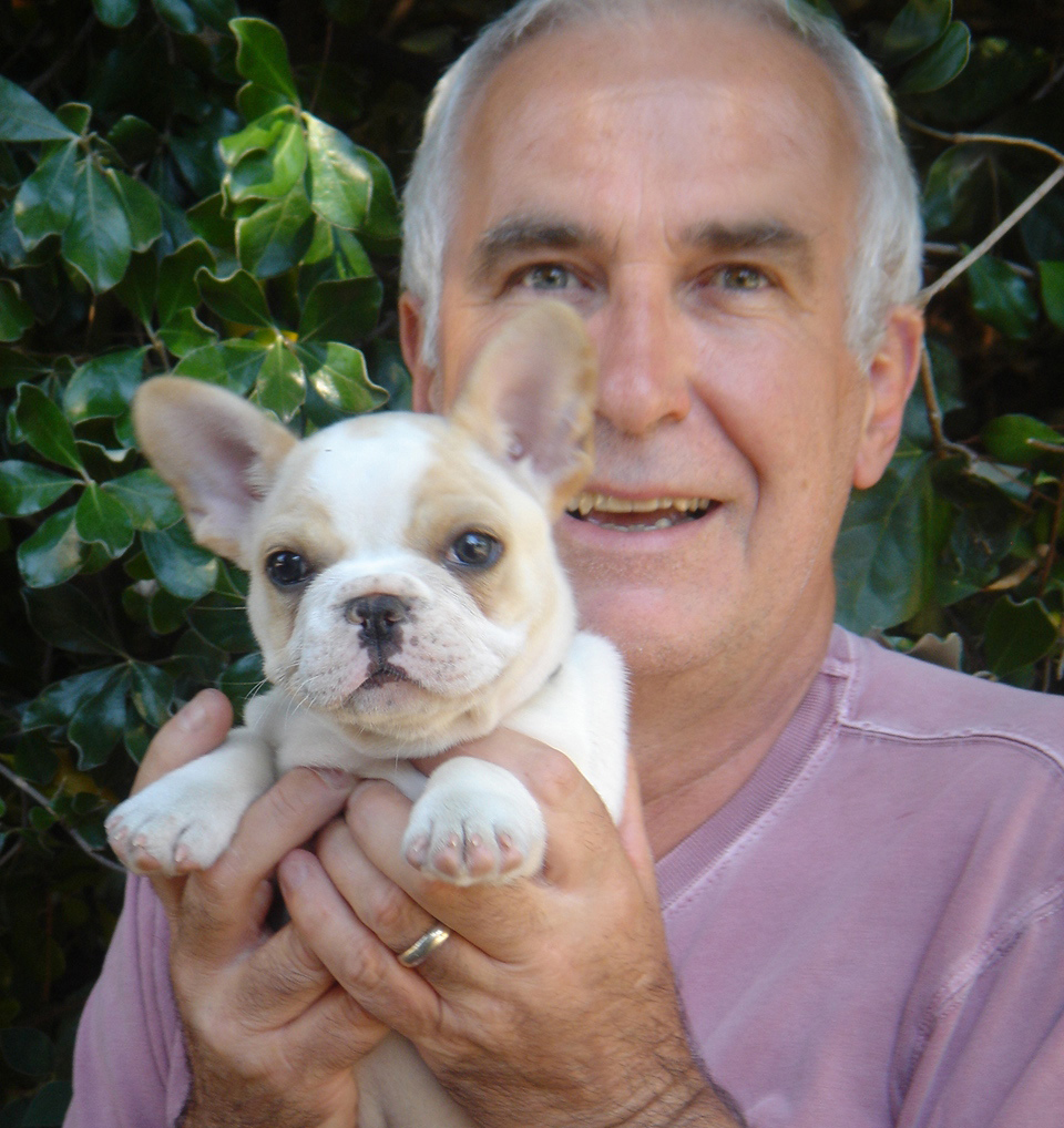 Dr. Ian Dunbar holding a French Bulldog puppy