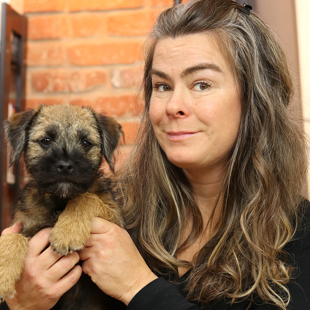 Kelly Gorman Dunbar holding a Border Terrier puppy