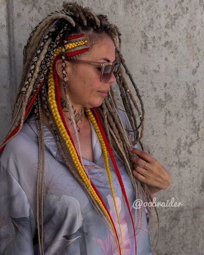 Blonde braids with red and yellow accents, hair by Olga Olikova
