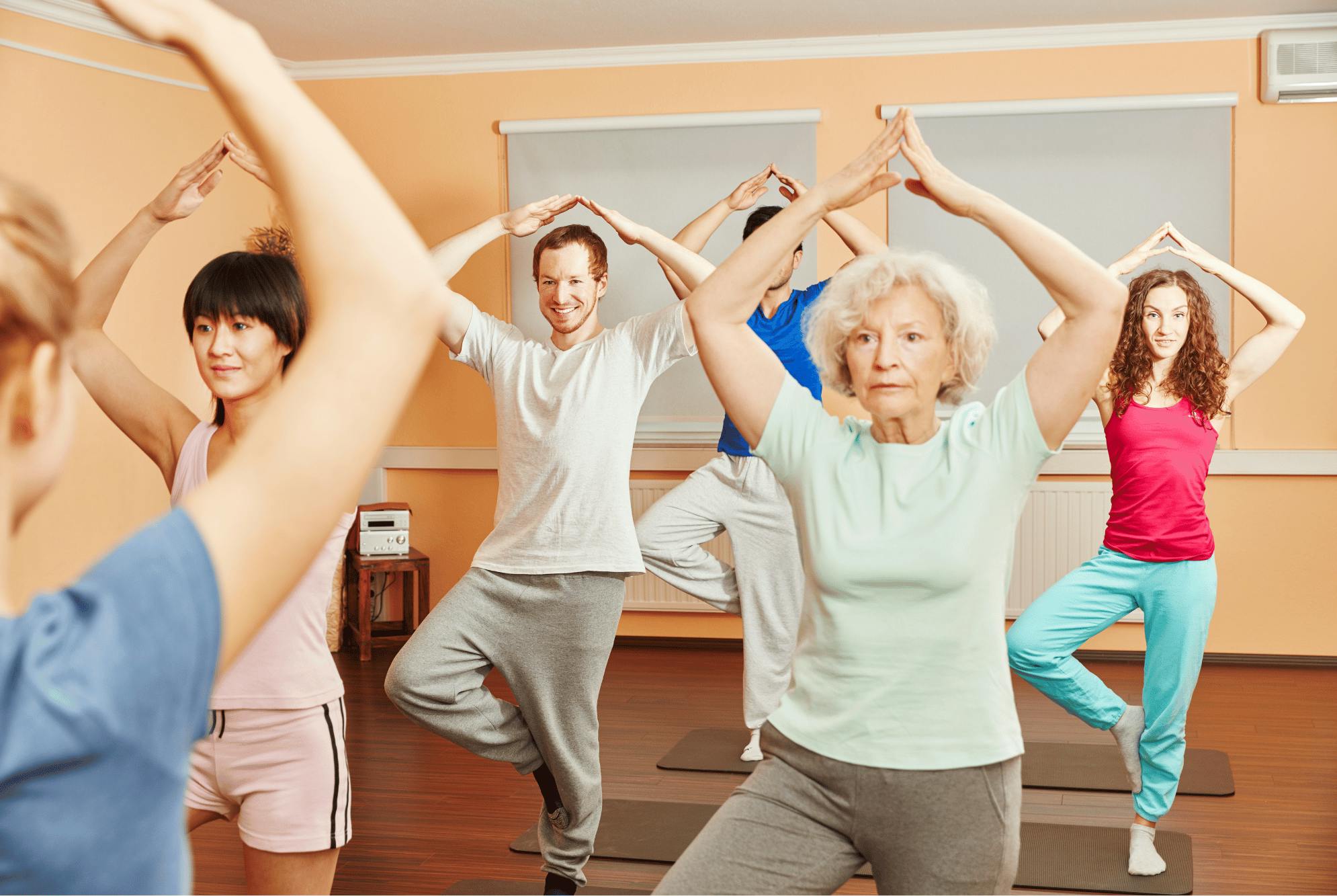 A group of people doing yogaDescription automatically generated
