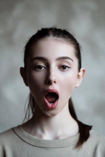 girl demonstrating vowels