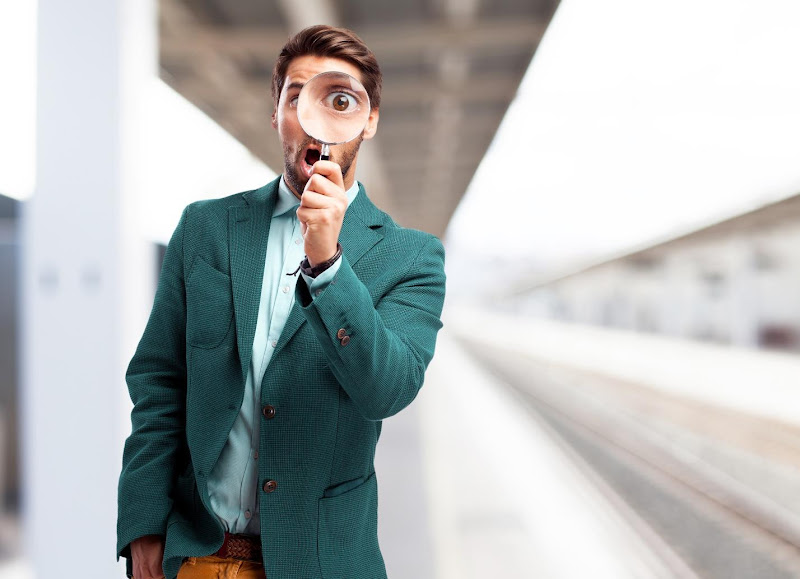 A person holding a magnifying glass AI-generated content may be incorrect.