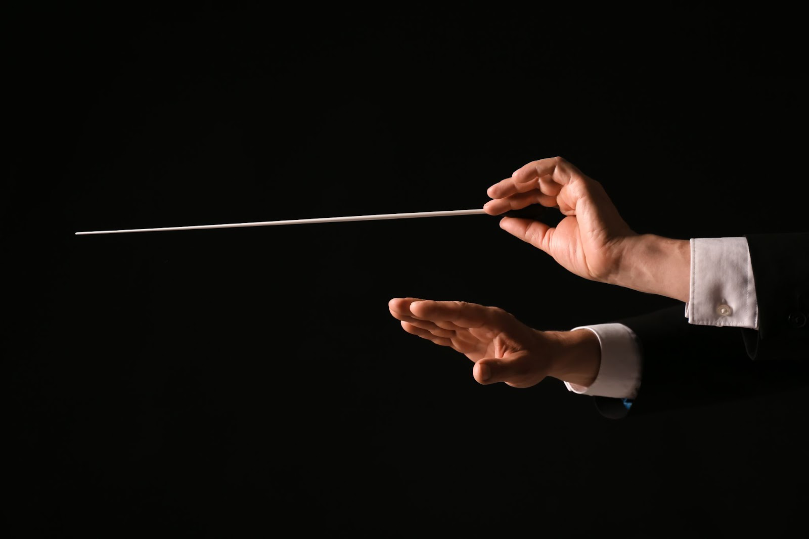 Orchestra conductors hands with baton
