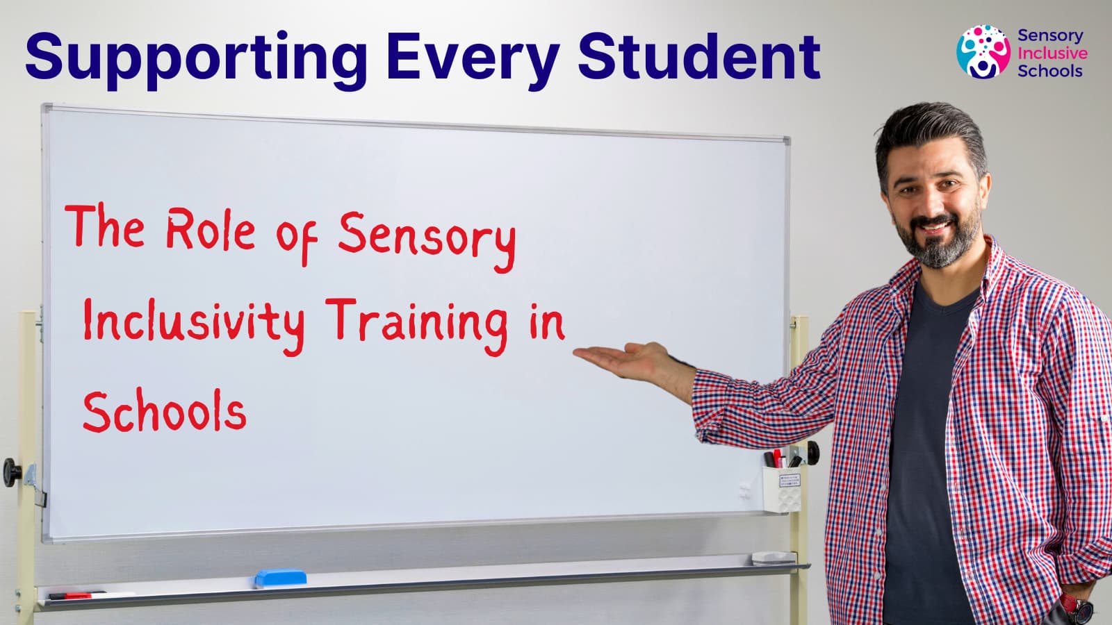 An adult points at a whiteboard. The text on the board reads "The Role of Sensory Inclusivity Training in Schools."