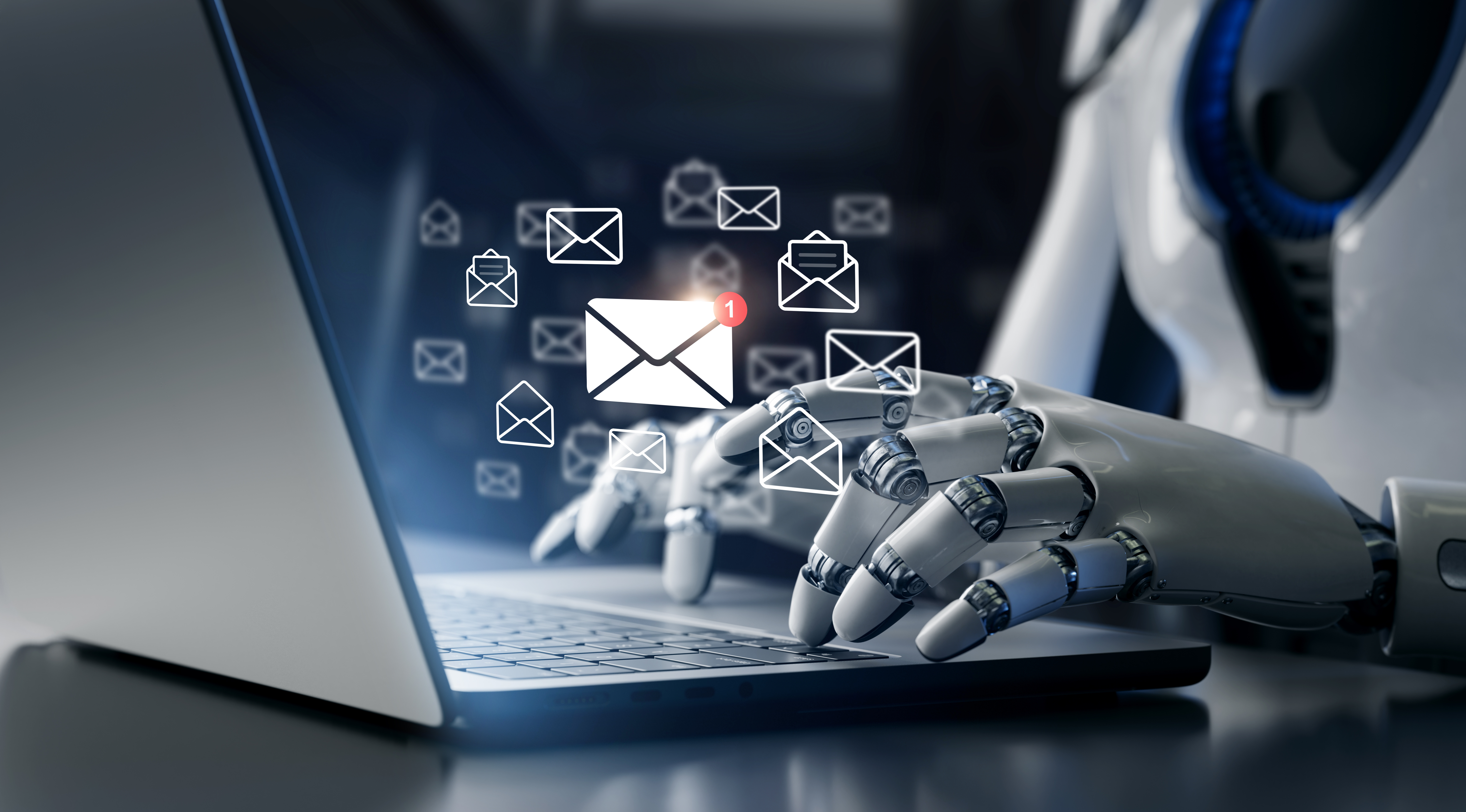 a robot types on an open laptop whilst email images float in front of it