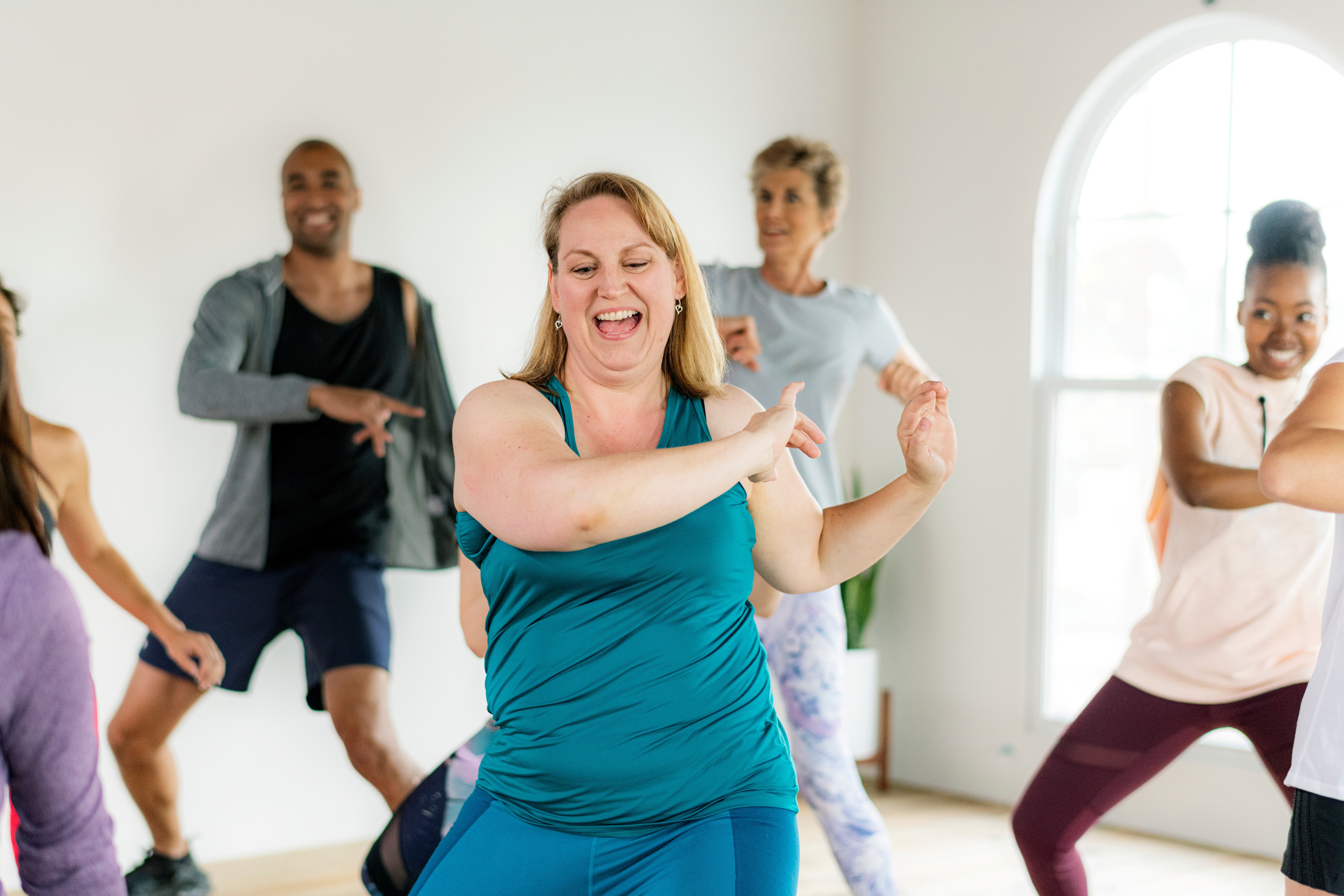 happy people dancing in a gym class