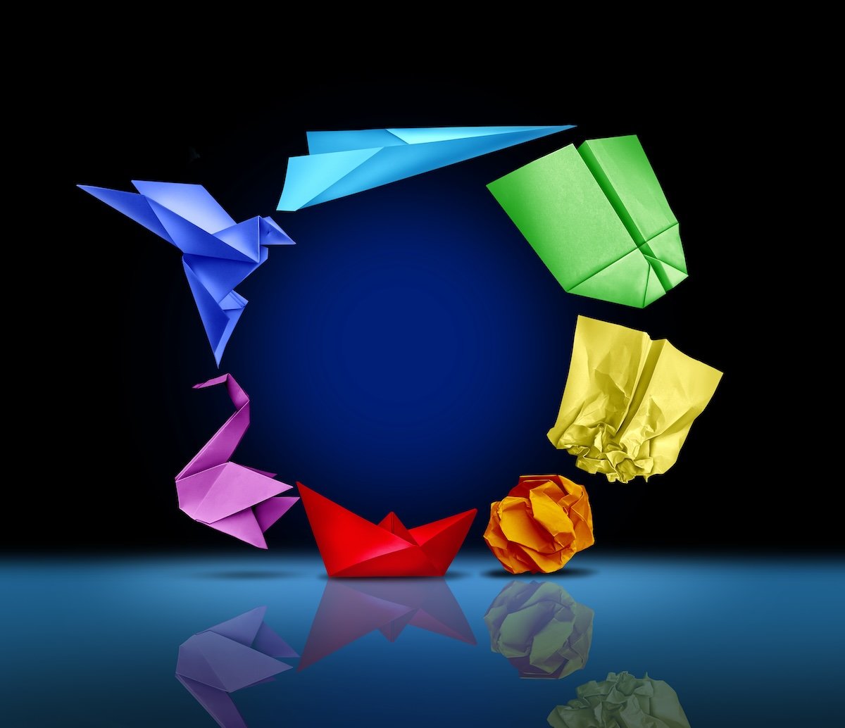 A circular formation of origami birds in flight, representing the evolution of Inclusion Learning Lab's work