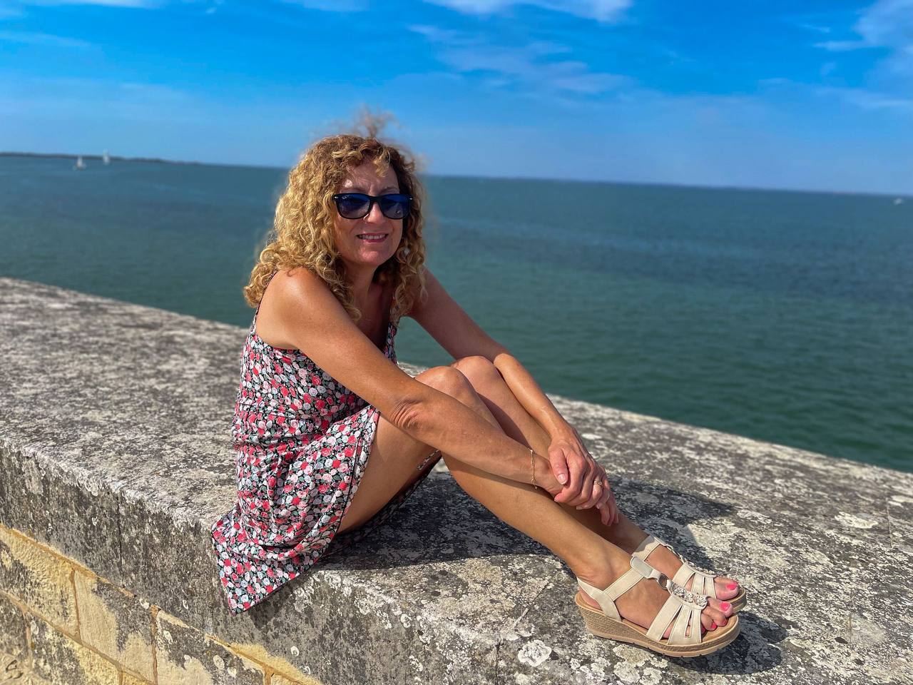 Sylviane sitting by the ocean